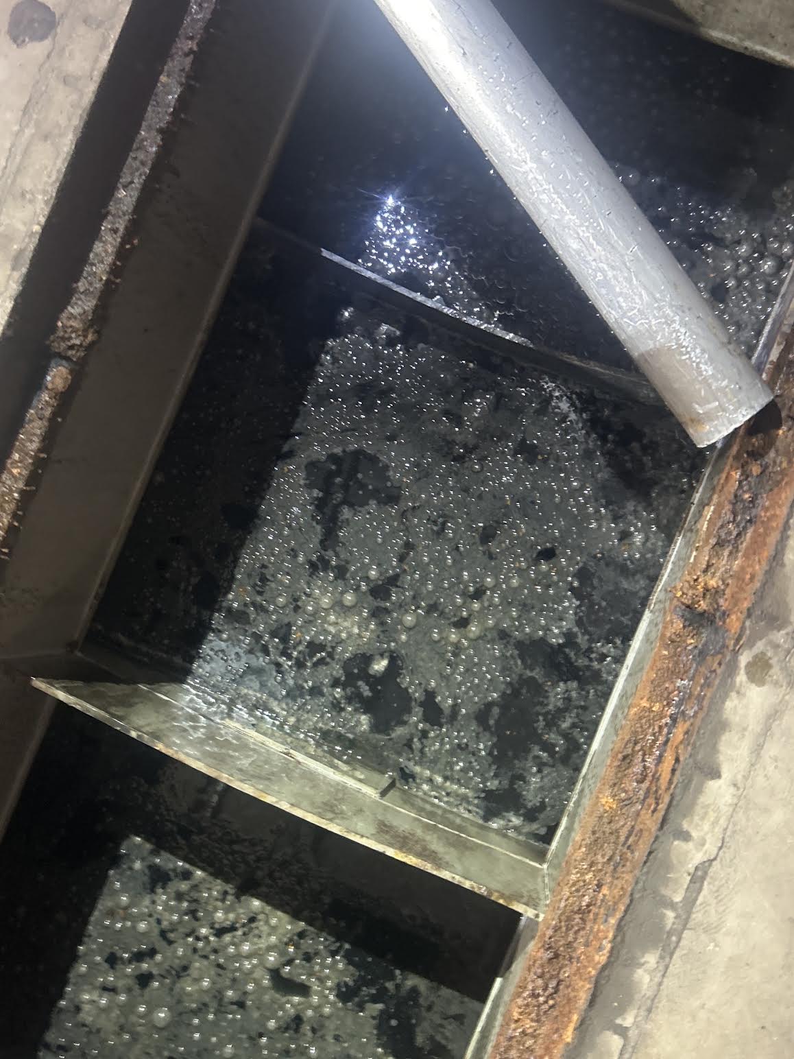 Vacuum hose collecting liquid from an oily-water pit