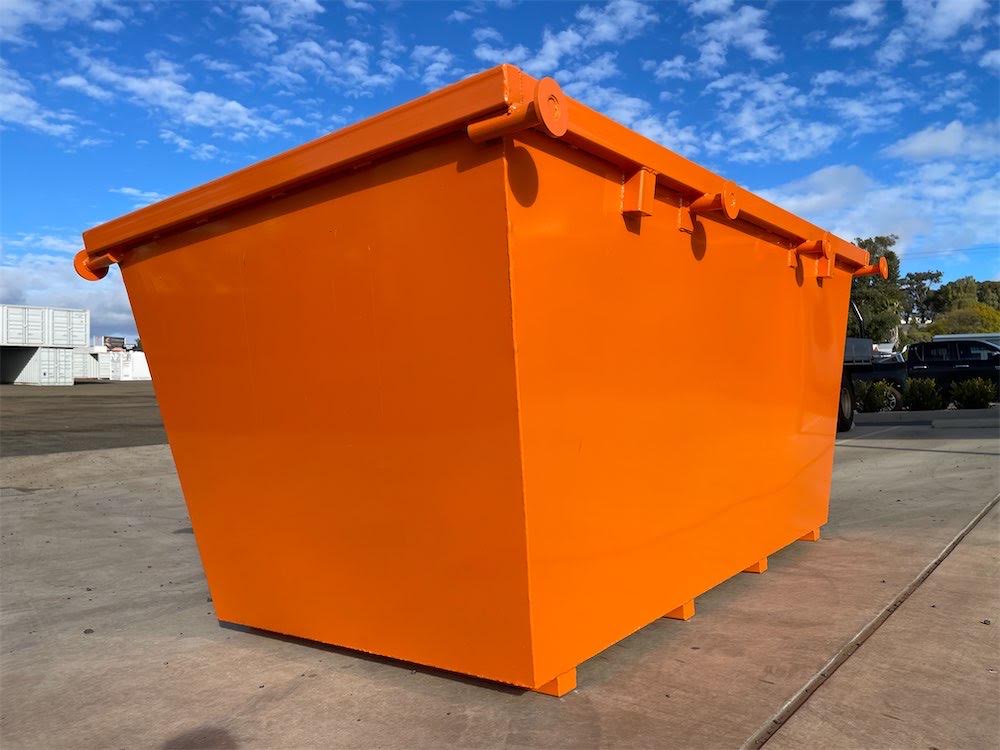 Empty four cubic metre Skip-It bin showing its top rail