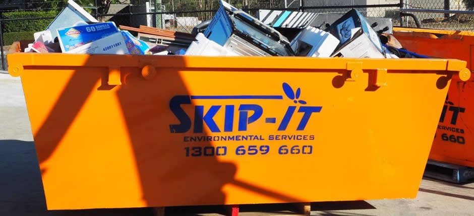 Skip-It orange skip bin loaded with household waste